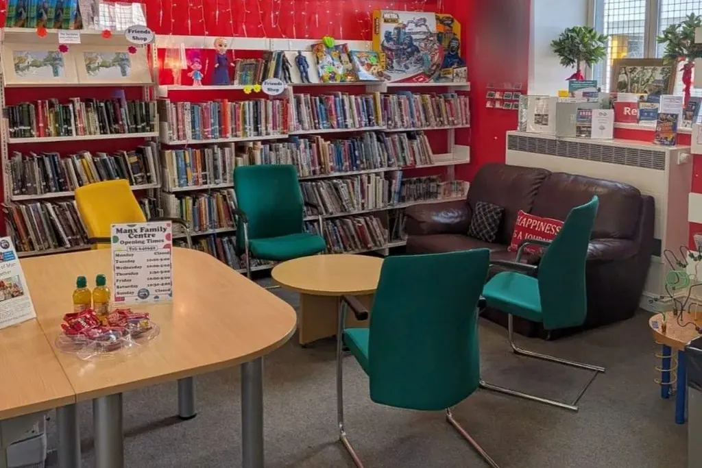 Inside the Manx Family Centre: bookshelves, seating and the family table