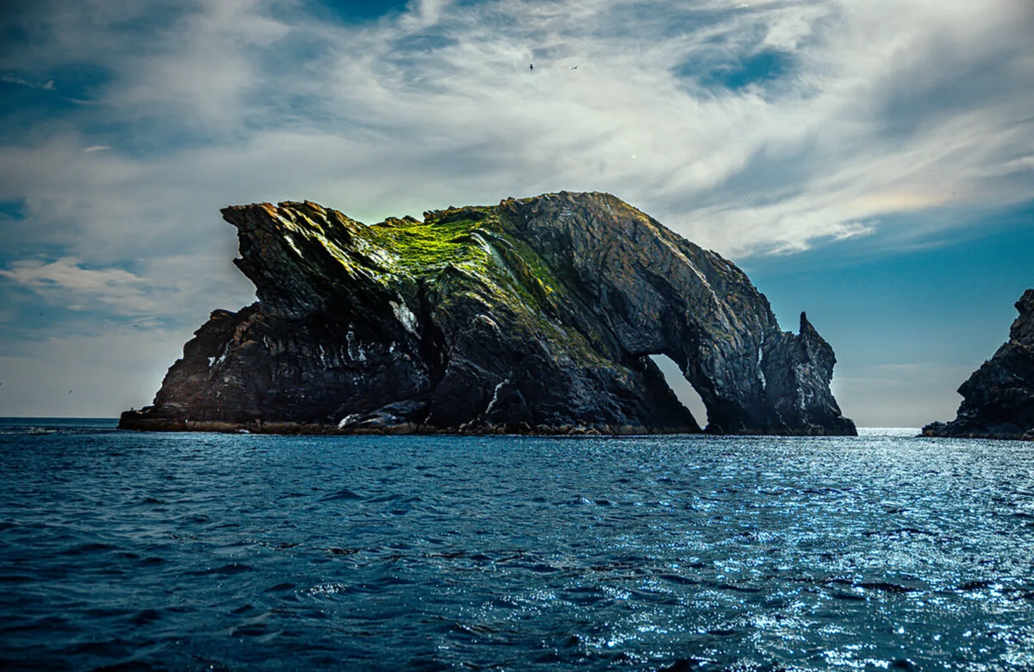 The Drinking Dragon rock formation off the Isle of Man coast, its arched head bowed towards the sea