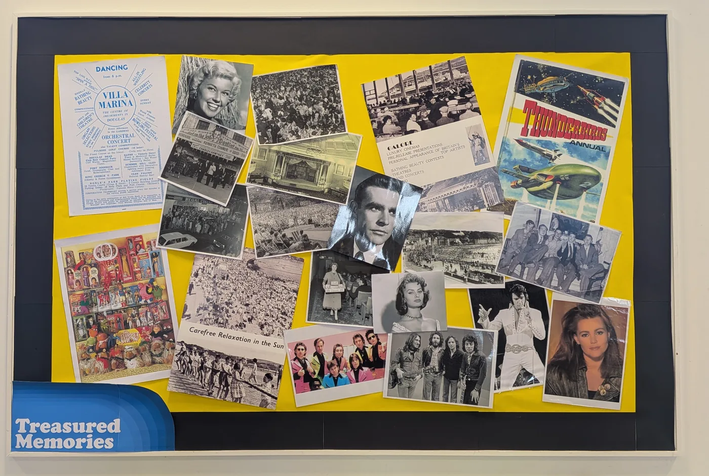 The Treasured Memories display board at the Centre, covered with photographs, posters and cuttings from the 1950s onwards